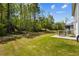 Sprawling backyard with lush green grass, a patio with outdoor seating, and mature trees at 1196 Erica Se Way, Atlanta, GA 30354