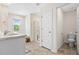 Well-lit bathroom featuring dual sinks, vanity with marble countertop, and a separate toilet room at 1196 Erica Se Way, Atlanta, GA 30354