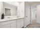 Bright bathroom with dual sinks and a large mirror over white cabinetry at 1196 Erica Se Way, Atlanta, GA 30354