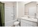 Clean bathroom with a tub/shower combo, modern sink, and neutral color scheme at 1196 Erica Se Way, Atlanta, GA 30354