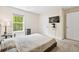 Bright bedroom featuring a queen bed, mounted TV, and sunlit window at 1196 Erica Se Way, Atlanta, GA 30354