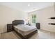 Cozy bedroom featuring a gray upholstered bed, two matching gray bedside tables and plush carpet at 1196 Erica Se Way, Atlanta, GA 30354