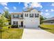 Charming two-story home featuring a manicured lawn, two-car garage, and neutral color palette at 1196 Erica Se Way, Atlanta, GA 30354