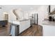 Kitchen island features granite countertops, stainless steel appliances, and luxury vinyl plank flooring at 1196 Erica Se Way, Atlanta, GA 30354