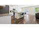 Bright kitchen with white cabinets, granite countertops, stainless steel appliances, and luxury vinyl plank flooring at 1196 Erica Se Way, Atlanta, GA 30354