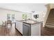Kitchen island features granite countertops, stainless steel appliances, and luxury vinyl plank flooring at 1196 Erica Se Way, Atlanta, GA 30354