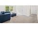 Inviting living space featuring a comfortable blue sofa set and soft neutral carpet at 1196 Erica Se Way, Atlanta, GA 30354