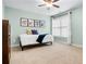 Well-lit bedroom with neutral paint, ceiling fan, plush carpeting, and bright window with custom blinds at 135 Haleys Cir, Woodstock, GA 30188