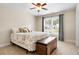 Bedroom with ceiling fan, comfortable carpet, natural light from the window, and convenient storage trunk at 135 Haleys Cir, Woodstock, GA 30188