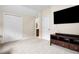 Bonus room featuring a mounted television and adjacent bathroom, offering entertainment and convenience for residents and guests at 135 Haleys Cir, Woodstock, GA 30188
