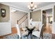Cozy dining room featuring wainscoting, a chandelier, and views of the staircase at 135 Haleys Cir, Woodstock, GA 30188