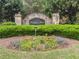Stone Haley's Mill entrance sign adorned with colorful flowers and trimmed hedges at 135 Haleys Cir, Woodstock, GA 30188