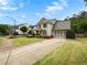 Lovely two-story home featuring an attached garage and long driveway surrounded by landscaped grounds at 135 Haleys Cir, Woodstock, GA 30188