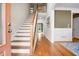 Bright foyer with hardwood floors, a staircase, and views into other rooms at 135 Haleys Cir, Woodstock, GA 30188