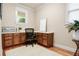 Dedicated home office with built-in desk, storage cabinets, and natural light at 135 Haleys Cir, Woodstock, GA 30188