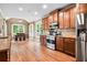 Modern kitchen with stainless steel appliances, granite counters, and hardwood floors at 135 Haleys Cir, Woodstock, GA 30188