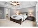 Serene main bedroom with tray ceiling, plush carpeting, and ample natural light at 135 Haleys Cir, Woodstock, GA 30188
