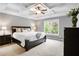 Spacious main bedroom featuring a tray ceiling, neutral décor, and comfortable carpeting at 135 Haleys Cir, Woodstock, GA 30188