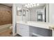 Bathroom features vanity with sink, mirror, and tiled shower/tub combo at 2007 Wingate Way, Atlanta, GA 30350