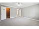 Bright bedroom with ceiling fan, carpet, and access to closet and bathroom at 2007 Wingate Way, Atlanta, GA 30350
