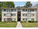 Apartment building exterior featuring traditional architecture, two stories, green lawn and a walkway entrance at 2007 Wingate Way, Atlanta, GA 30350