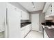 Well-lit kitchen with white cabinets, black countertops, and updated appliances at 2007 Wingate Way, Atlanta, GA 30350
