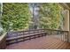 Spacious back deck with built-in bench overlooking a lush green wooded area at 3045 Wyntree Dr, Peachtree Corners, GA 30071