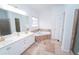 Bright bathroom featuring a jacuzzi tub, dual sink vanity, and separate shower at 3045 Wyntree Dr, Peachtree Corners, GA 30071
