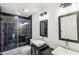 Modern bathroom featuring double sinks, a black tile shower, framed mirrors and pendant lighting at 3045 Wyntree Dr, Peachtree Corners, GA 30071