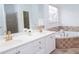 Bright bathroom featuring a jacuzzi tub, dual sink vanity, and separate shower at 3045 Wyntree Dr, Peachtree Corners, GA 30071