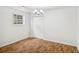 Cozy bedroom featuring hardwood floors, a bright window, and a double-door closet at 3045 Wyntree Dr, Peachtree Corners, GA 30071