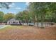 A tranquil shot of the community pool and clubhouse surrounded by a lush tree line at 3045 Wyntree Dr, Peachtree Corners, GA 30071