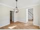 Dining room with wood floors and decorative chandelier at 3045 Wyntree Dr, Peachtree Corners, GA 30071
