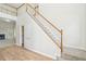 Bright foyer featuring a staircase with a wooden railing and a view of the adjacent living area at 3045 Wyntree Dr, Peachtree Corners, GA 30071