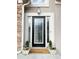 Elegant front door with decorative glass, flanked by planters, and a welcoming 'Welcome' mat at 3045 Wyntree Dr, Peachtree Corners, GA 30071
