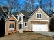 Charming two-story home featuring a stone and stucco exterior with an attached two-car garage at 3045 Wyntree Dr, Peachtree Corners, GA 30071