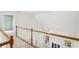 Hallway features a wooden railing, ceiling fan, and view of the living room below at 3045 Wyntree Dr, Peachtree Corners, GA 30071