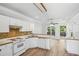 Kitchen with tile backsplash, white appliances and breakfast bar at 3045 Wyntree Dr, Peachtree Corners, GA 30071