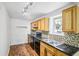 Charming kitchen features granite countertops, black appliances, and a tile backsplash at 3045 Wyntree Dr, Peachtree Corners, GA 30071