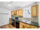 Updated kitchen featuring granite countertops, black appliances, and stainless steel sink at 3045 Wyntree Dr, Peachtree Corners, GA 30071