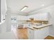 Galley kitchen features white cabinets and modern countertops, offering a functional space at 3045 Wyntree Dr, Peachtree Corners, GA 30071