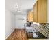 Well-lit kitchen with granite counters, oak cabinets, and mosaic backsplash at 3045 Wyntree Dr, Peachtree Corners, GA 30071