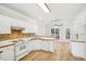 Kitchen with white appliances, breakfast bar and view to the deck at 3045 Wyntree Dr, Peachtree Corners, GA 30071