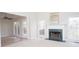 Spacious living room featuring a marble fireplace and large windows that provide ample natural light at 3045 Wyntree Dr, Peachtree Corners, GA 30071