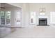 Spacious living room featuring a fireplace with a green marble surround and large windows providing natural light at 3045 Wyntree Dr, Peachtree Corners, GA 30071