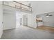 Open concept living area with hardwood floors, a cozy loft, and a bright kitchen in the background at 3045 Wyntree Dr, Peachtree Corners, GA 30071