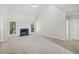 Spacious living room featuring a fireplace with a green marble surround and large windows providing natural light at 3045 Wyntree Dr, Peachtree Corners, GA 30071