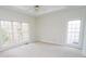 Light and airy main bedroom with carpeted floors, ceiling fan, and multiple windows at 3045 Wyntree Dr, Peachtree Corners, GA 30071