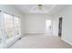 Light and airy main bedroom with carpeted floors, ceiling fan, and multiple windows at 3045 Wyntree Dr, Peachtree Corners, GA 30071