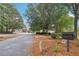 Street view of Wynfree community with mature trees and welcoming signage at 3045 Wyntree Dr, Peachtree Corners, GA 30071